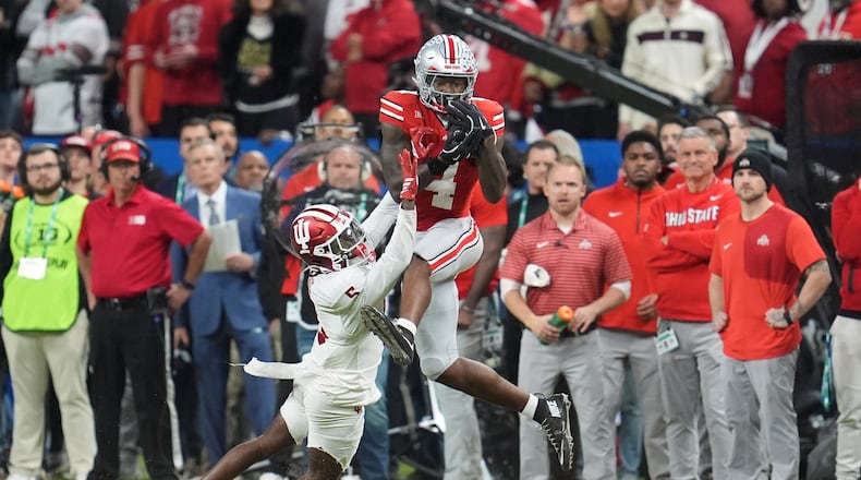 Ohio State's Jeremiah Smith catches a pass in front of Indiana's D'Angelo Ponds during the second half of the Big Ten championship NCAA college football game in Indianapolis, Saturday, Dec. 6, 2025. (AP Photo/Michael Conroy)
