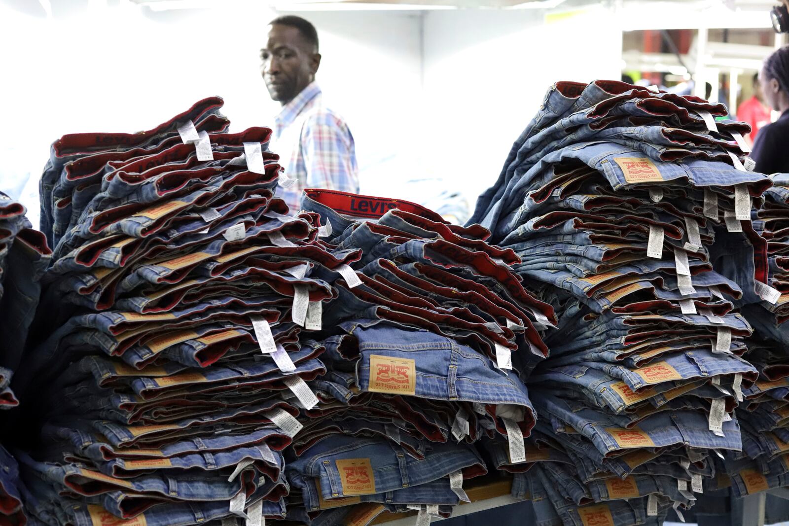 A label reading "Levis" on a pair of Levi Strauss & Co jeans are displayed at a production line at United Aryan EPZ Limited in Ruaraka on the outskirts of Nairobi, Kenya Friday, March. 21, 2025. (AP Photo/Andrew Kasuku)