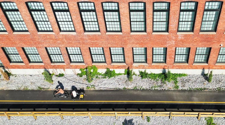Phase 3 of the Hamilton Beltline Trail project is complete. This phase is from North B Street south along the top of the Great Miami River levee and next Spooky Nook Champion Mill convention center and hotel. It leads to the High-Main Bridge. Phase 4 is planned to go from Eaton Avenue to Main Street. Pictured is the trail from next to The Warehouse Hotel at Spooky Nook. NICK GRAHAM/STAFF