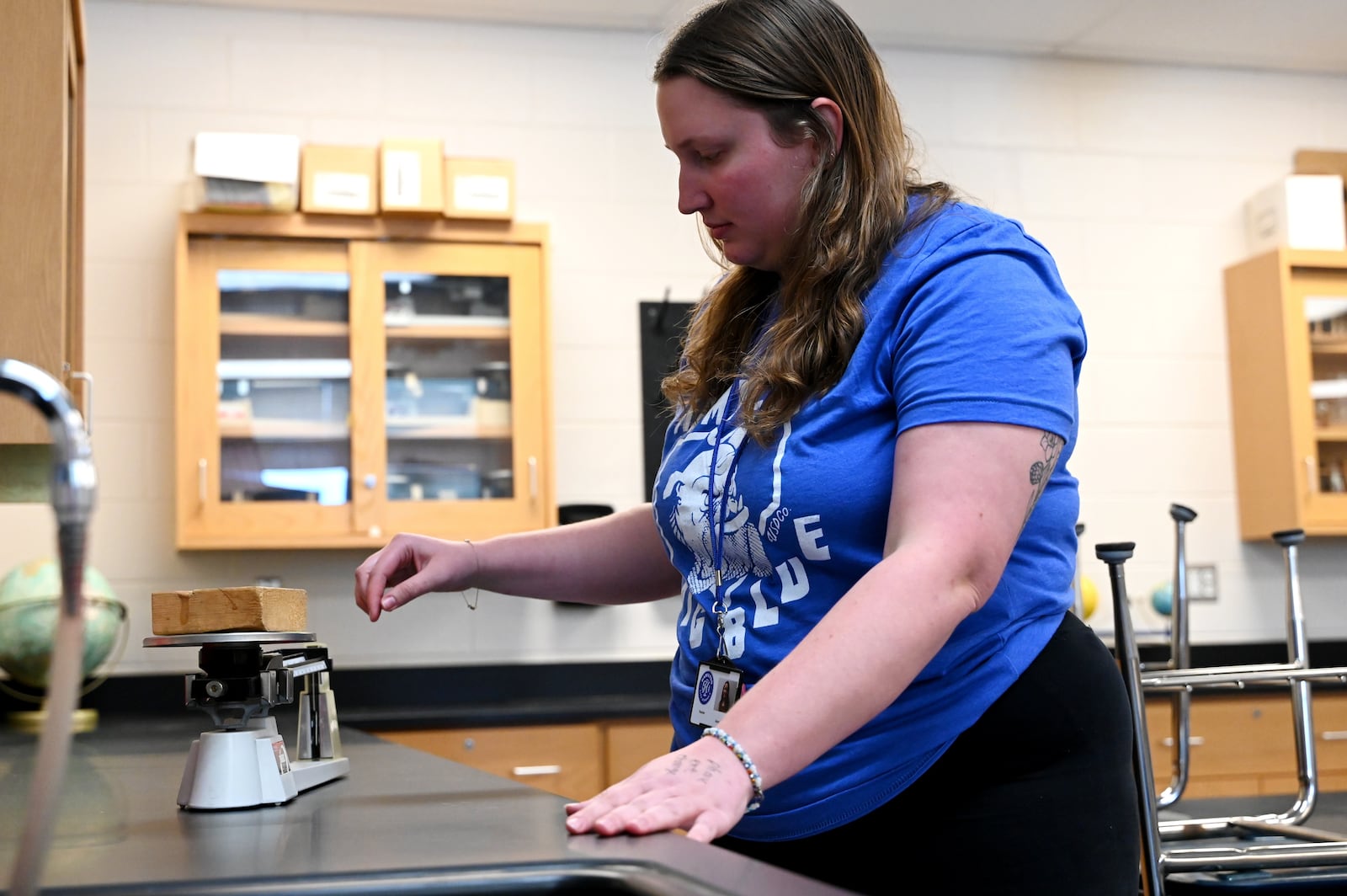 Anna Tumlin is a first-year teacher at Wilson Middle School in the Hamilton City School District. She teaches seventh-grade science. Pictured is Tumlin on Wednesday, Aug. 6, 2025, calibrating a piece of equipment during her set up of her classroom ahead of the upcoming school year, which starts the week of Aug. 11, 2025. Half the students will report on Monday, Aug. 11 and the other half report on Tuesday, Aug. 12. All students report to school on Wednesday, Aug. 13. MICHAEL D. PITMAN/STAFF