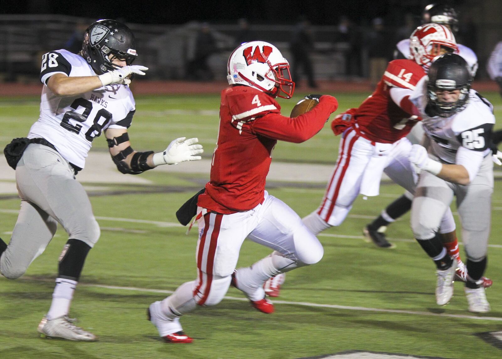 Lakota West running back Zelwyn Robinson (4) runs toward the sideline during the first half of a Division I playoff game against Lakota East at Mason on Nov. 15, 2014. GREG LYNCH/STAFF