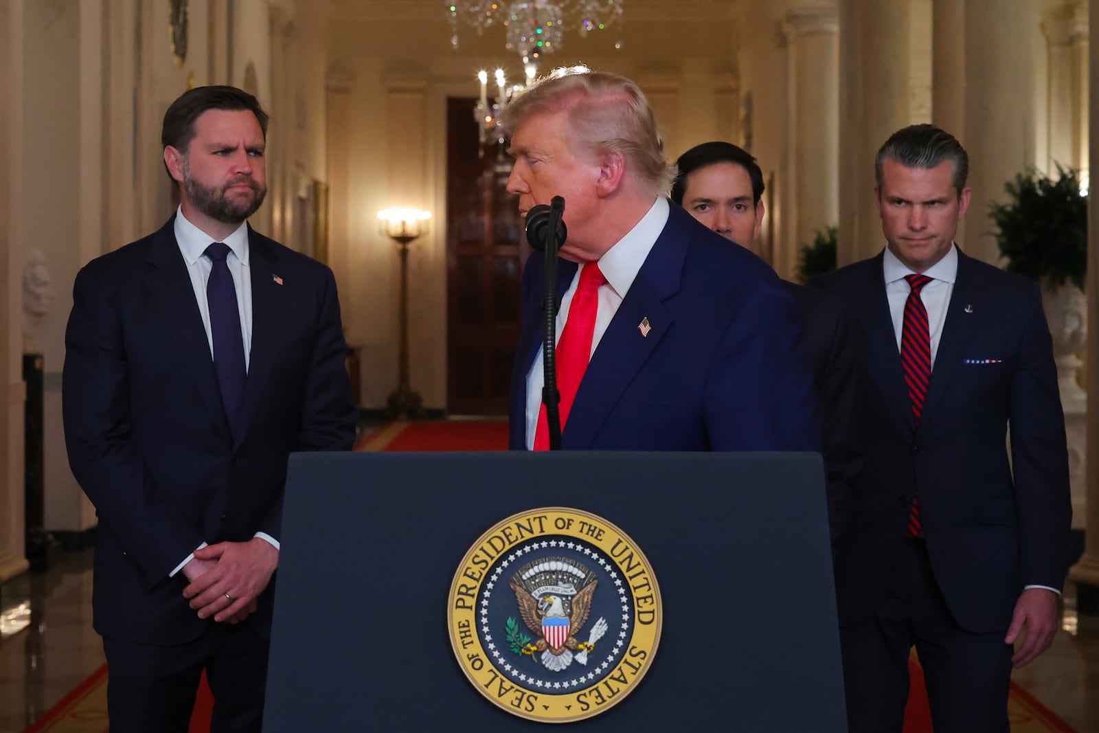 President Donald Trump turns from the podium after speaking from the East Room of the White House in Washington, Saturday, June 21, 2025, after the U.S. military struck three Iranian nuclear and military sites, directly joining Israel's effort to decapitate the country's nuclear program, as Vice President JD Vance, Secretary of State Marco Rubio and Defense Secretary Pete Hegseth listen. (Carlos Barria/Pool via AP)