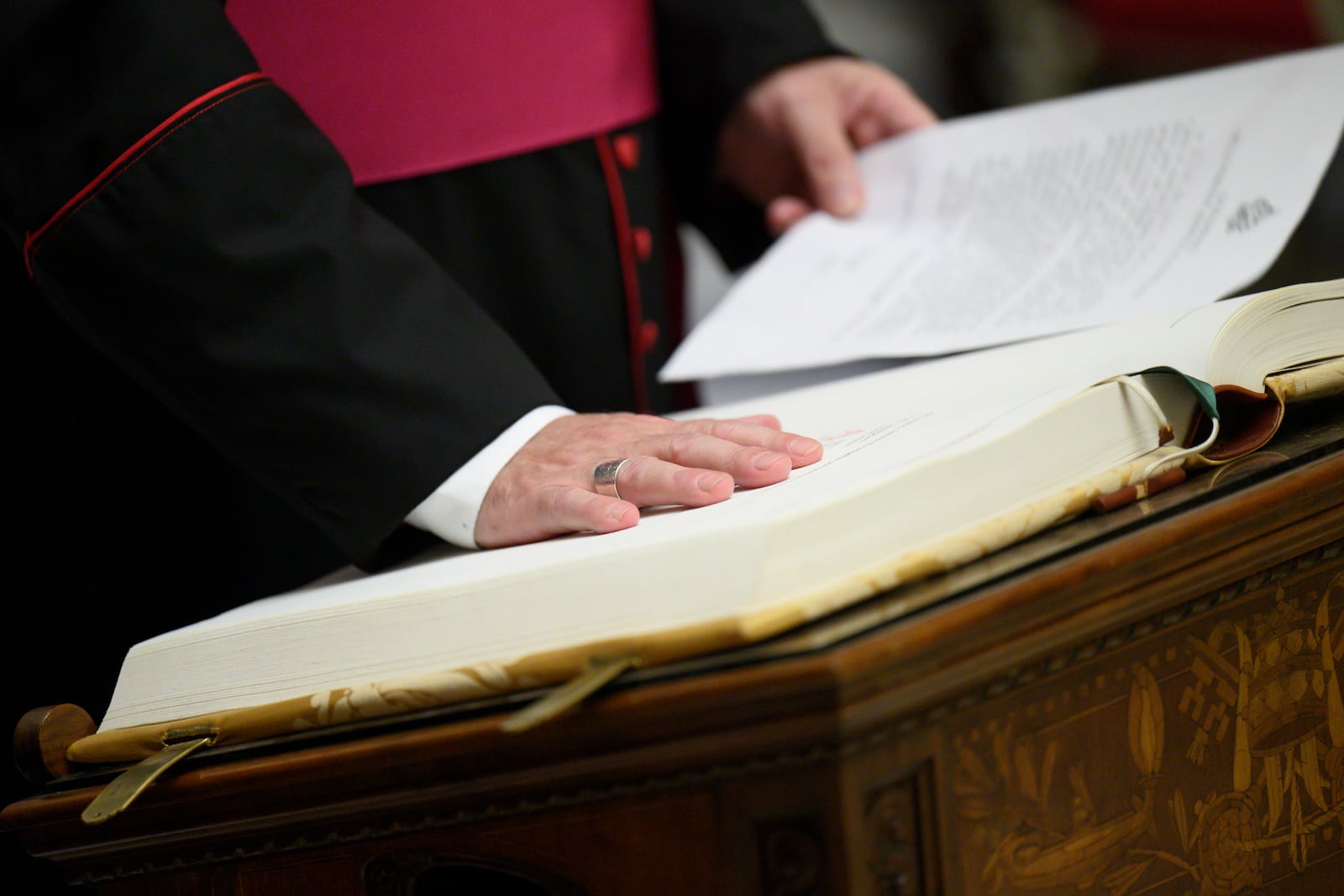 In this image made available on Tuesday, May 6, 2025 by Vatican Media, Vatican Master of Ceremonies Archbishop Diego Giovanni Ravelli takes the oath of secrecy for all those assigned to the conclave during a ceremony in the Pauline Chapel at the Vatican, Monday, May 5, 2025. (Vatican Media via AP)