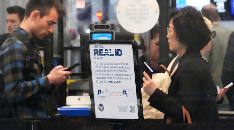 FILE - A Real ID sign is displayed as Travelers wait to go through security check point at O'Hare International Airport in Chicago, May 23, 2025. (AP Photo/Nam Y. Huh, File)
