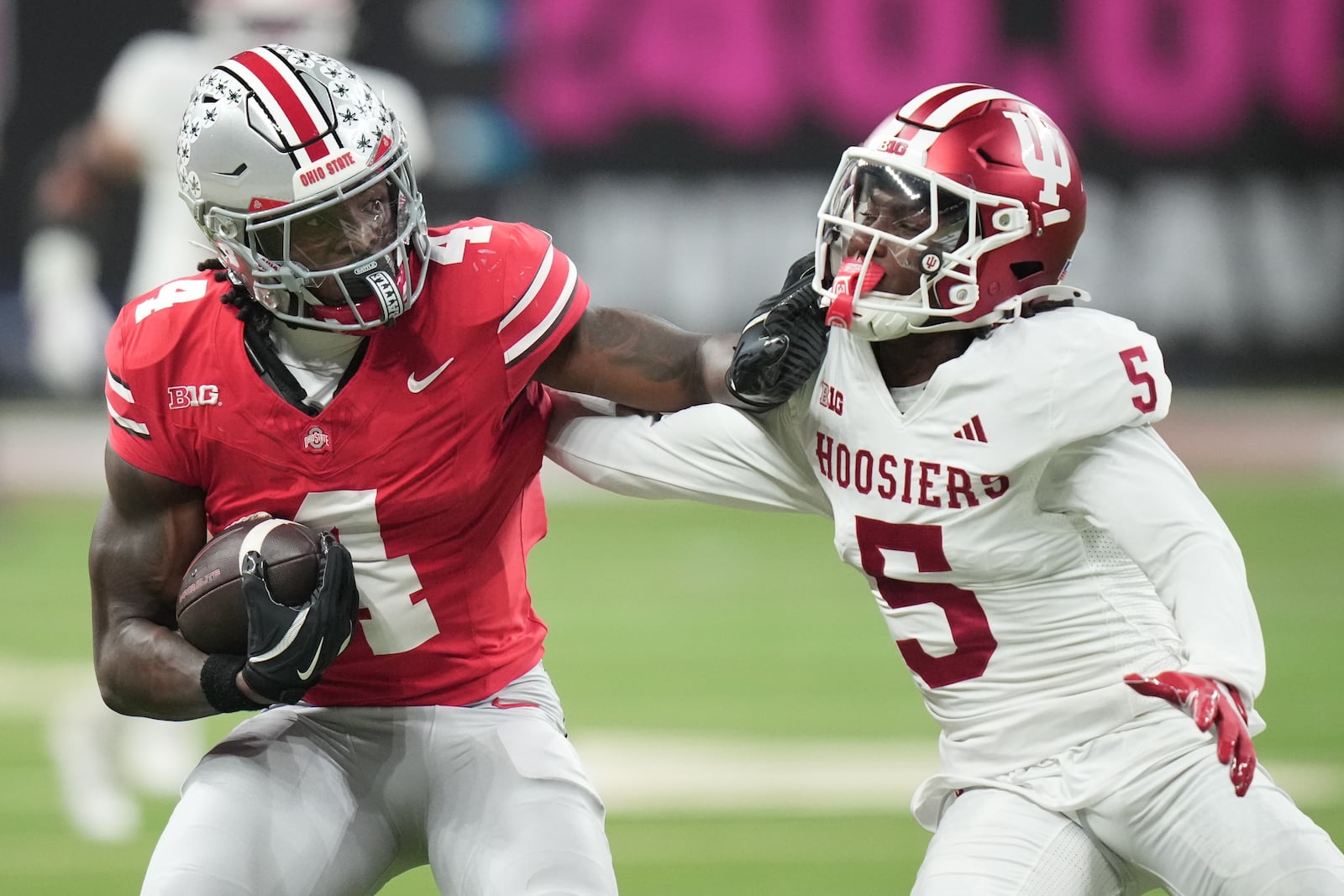 Indiana's D'Angelo Ponds tries to stop Ohio State's Jeremiah Smith during the first half of the Big Ten championship NCAA college football game in Indianapolis, Saturday, Dec. 6, 2025. (AP Photo/AJ Mast)