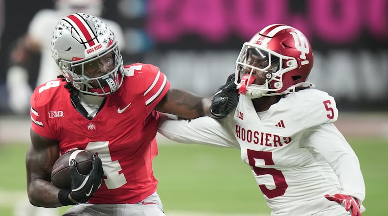 Indiana's D'Angelo Ponds tries to stop Ohio State's Jeremiah Smith during the first half of the Big Ten championship NCAA college football game in Indianapolis, Saturday, Dec. 6, 2025. (AP Photo/AJ Mast)
