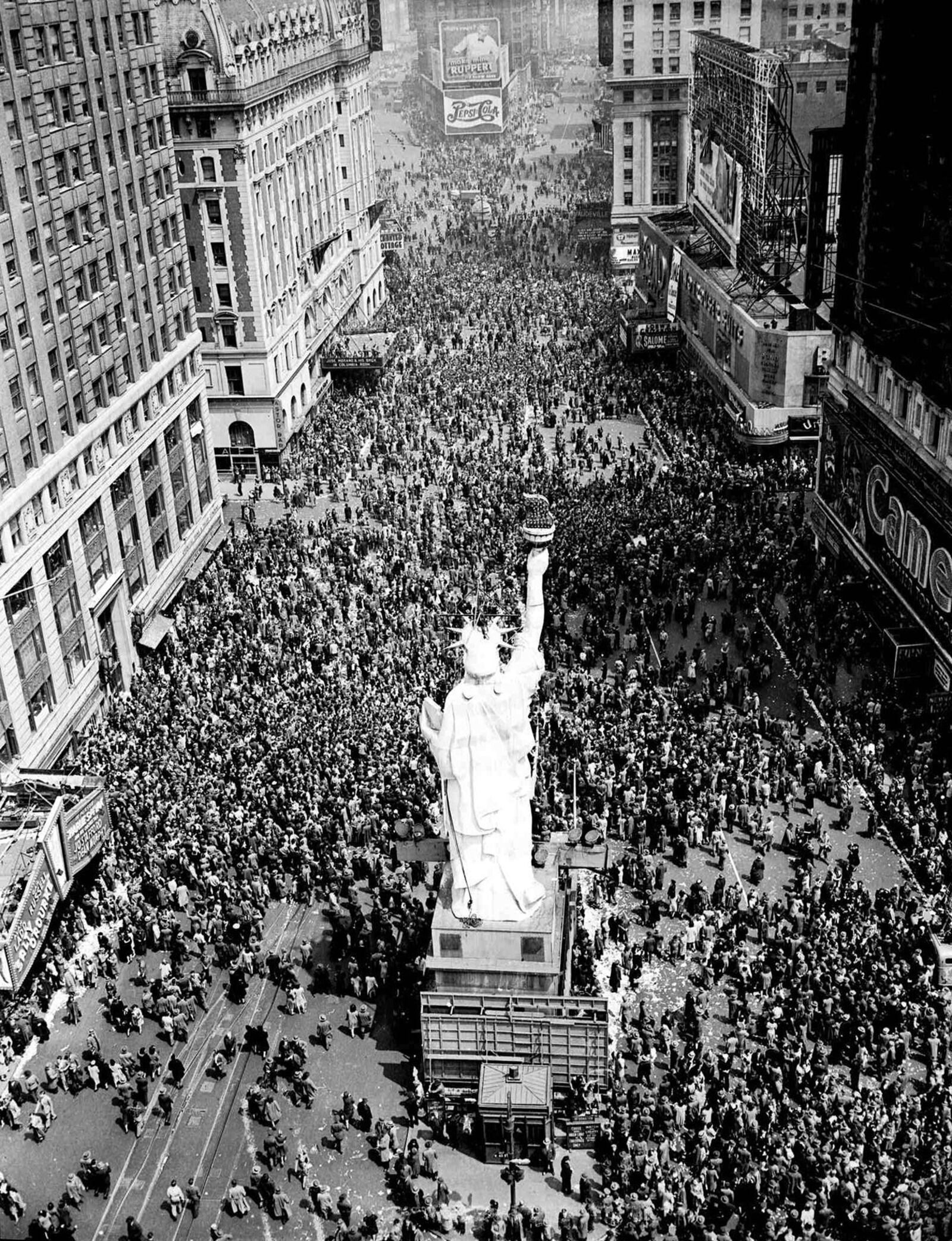 People crowd Times Square at 42nd Street in New York City on May 8, 1945, as the V-E Day celebration continues into the night. (AP Photo/Matty Zimmerman, File)