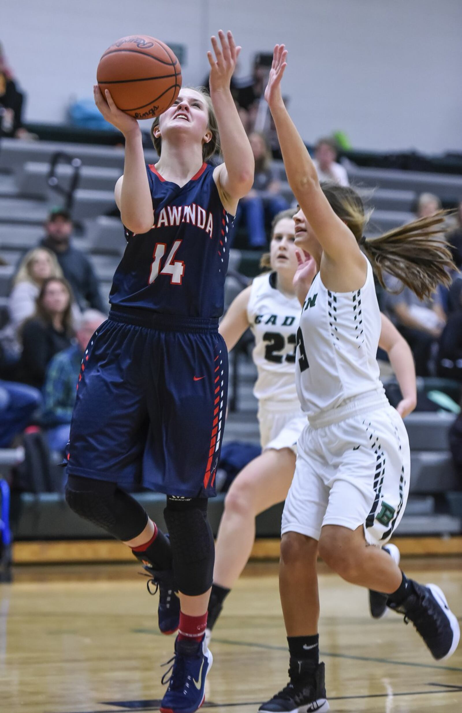 Talawanda’s Addie Brown puts up a shot while being defended by Badin’s Ally Stang during their game Monday night at Mulcahey Gym in Hamilton. NICK GRAHAM/STAFF