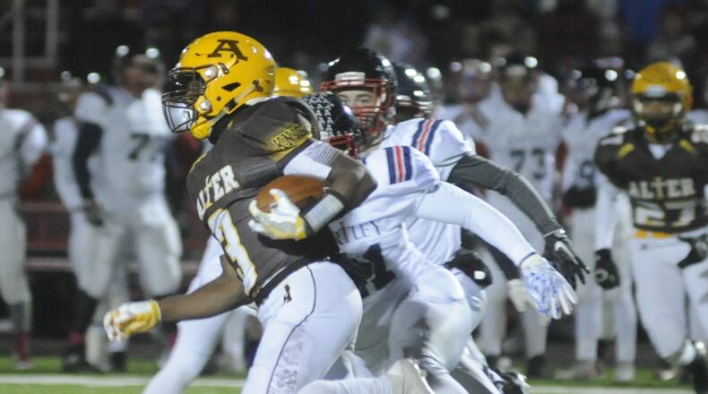 Alter’s John Bivens returns a first-half kickoff 59 yards to set up a score. Alter played Columbus Bishop Hartley in a D-IV high school football state semifinal game at London on Friday, Nov. 25, 2016. MARC PENDLETON / STAFF