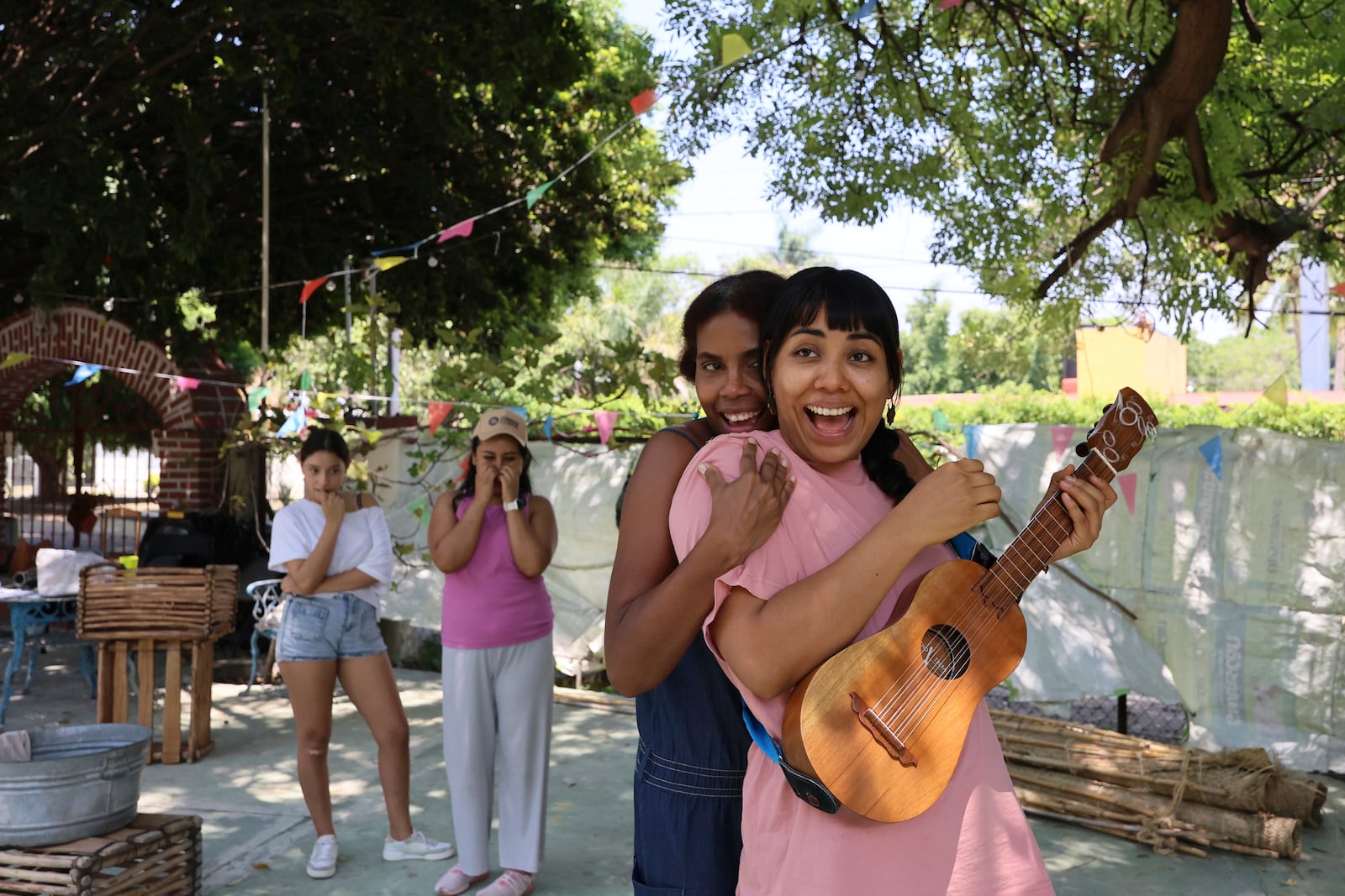 Mulato Teatro cast members Eréndira Castorela, strumming a jarana jarocha, and Marisol Castillo, rehearse for their upcoming performance in the First International Afro-Scenic Festival, in Ticumán, Mexico, Saturday, May 17, 2025. (AP Photo/Ginnette Riquelme)