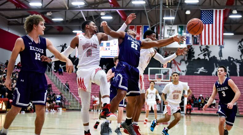 Elder’s Joe Royer (12) and Bryson Merz (23) batlle for the ball with Fairfield’s Devin Turner (0) and Caleb Pryce (5) during Friday night’s game at the Fairfield Arena. Elder won 62-55. NICK GRAHAM/STAFF