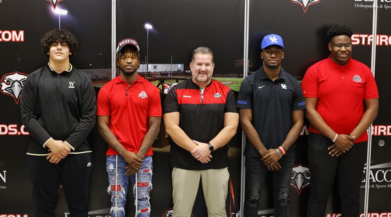 Left to right: Latham McComis, Jyaire Brown, Lakota West head football coach Tom Bolden, Alex Afari and Tegra Tshabola stand for photos during a national letter of intent college football signing ceremony Wednesday, Dec. 15, 2021 at Lakota West High School. Latham McComis is signing with Wofford College, Jyaire Brown is signing with The Ohio State University, Alex Afari is signing with University of Kentucky and Tegra Tshaboa is signing with The Ohio State University. NICK GRAHAM / STAFF