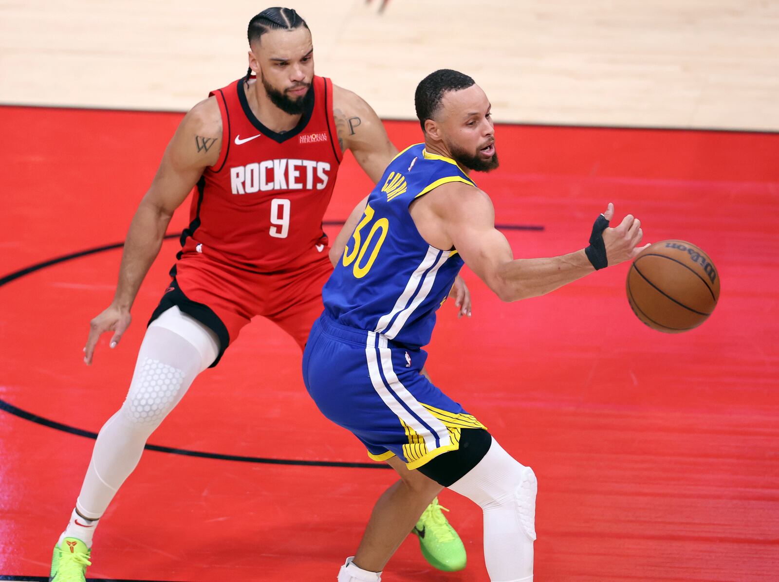 Golden State Warriors' Stephen Curry (30) has a pass go off his hand for a turnover while being defended by Houston Rockets' Dillon Brooks (9) during the first half of Game 1 of an NBA basketball first-round playoff series in Houston, Sunday, April 20, 2025. (Scott Strazzante/San Francisco Chronicle via AP)
