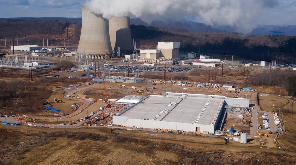 FILE - A data center owned by Amazon Web Services, front right, is under construction next to the Susquehanna nuclear power plant in Berwick, Pa., Jan. 14, 2025. (AP Photo/Ted Shaffrey, File)
