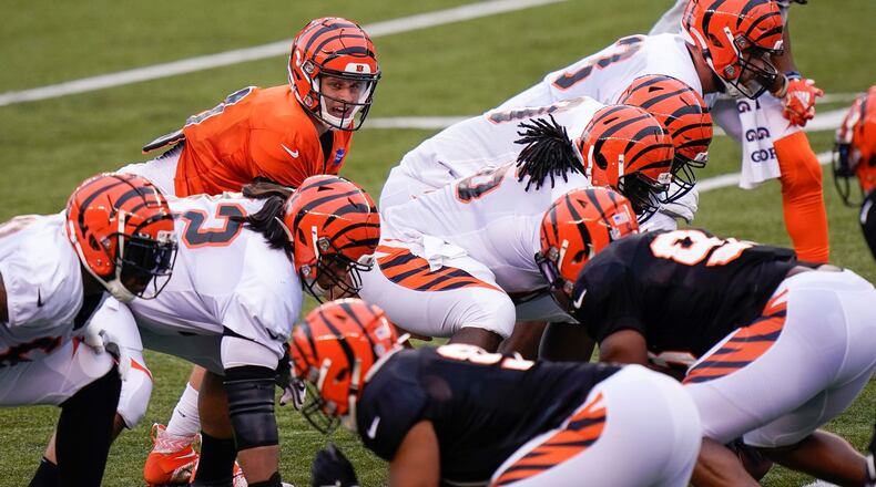 Cincinnati Bengals quarterback Joe Burrow (9) lines up under center during an NFL football team scrimmage in Cincinnati, Sunday, Aug. 30, 2020. (AP Photo/Bryan Woolston)