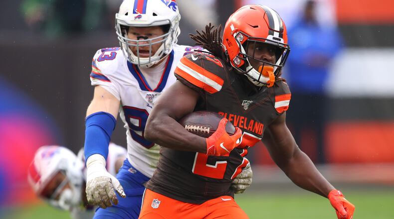 CLEVELAND, OHIO - NOVEMBER 10: Kareem Hunt #27 of the Cleveland Browns runs for a first down in front of Trent Murphy #93 of the Buffalo Bills during the second half at FirstEnergy Stadium on November 10, 2019 in Cleveland, Ohio. Cleveland won the game 19-17. (Photo by Gregory Shamus/Getty Images)