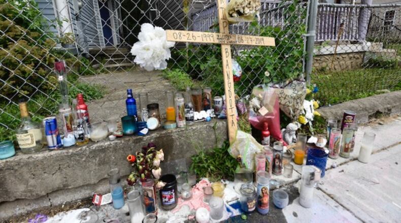 The memorial on East Avenue for Shon Walker who was shot and killed July 2y has grown. NICK GRAHAM/STAFF