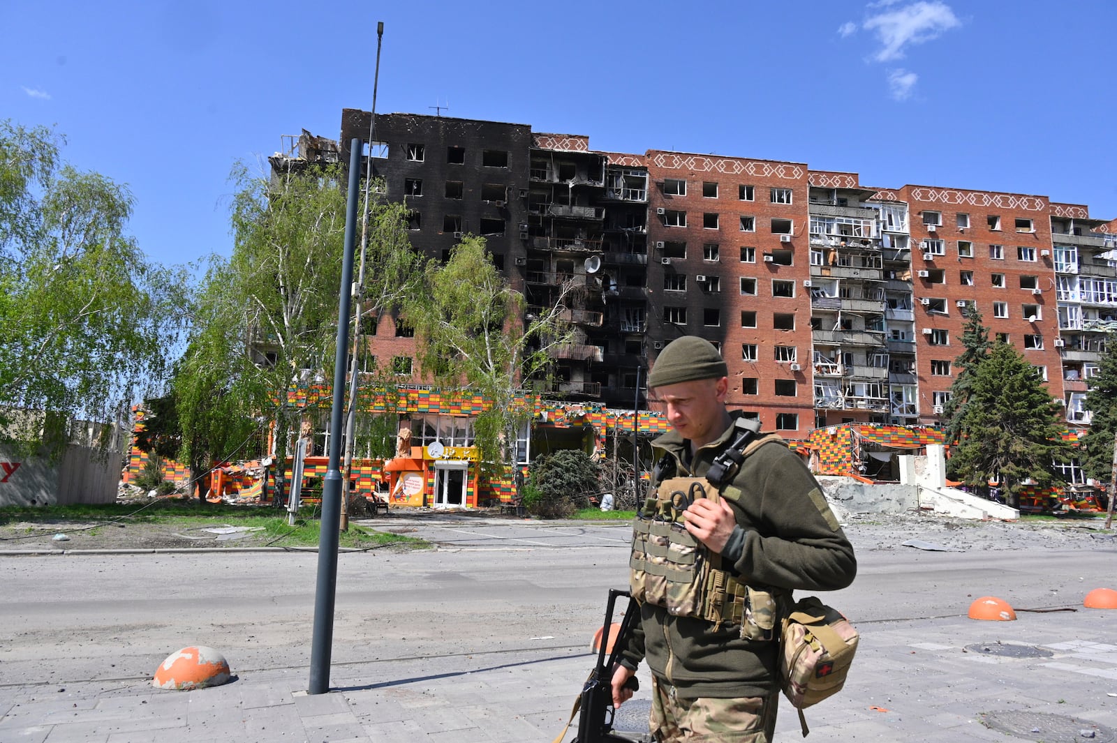 FILE - A Ukrainian soldier walks past damaged buildings in central Pokrovsk, the site of the heaviest battles with the Russian troops in the Donetsk region of Ukraine, April 23, 2025. (AP Photo/Michael Shtekel, File)