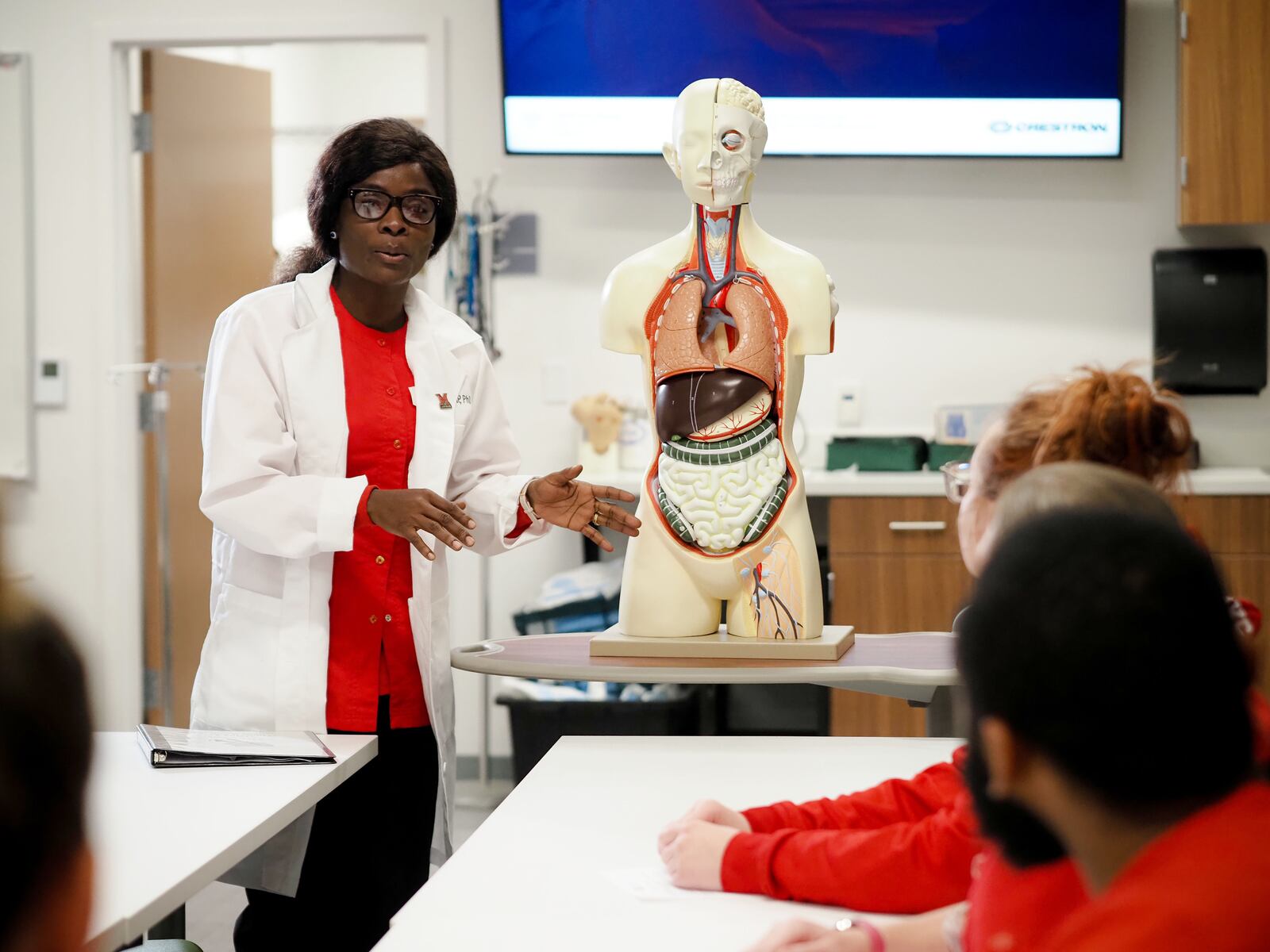 The death of a hospitalized family member in Ghana, West Africa due to a shortage of nurses both haunted and motivated Effe Addae, who later to come to America to earn a degree in nursing to ensure those suffering will never again lack those who care. Now an American citizen and married mother of four, Addae - shown her helping to instruct a nursing class - will step on to a stage Sunday during commencement at the Goggin Ice Center in Oxford and receive her Bachelor of Science in Nursing diploma earned through classes at Miami University’s Hamilton regional campus. (Provided Photo\Journal-News)