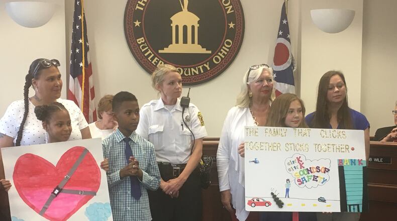 Khloe Warren (holding poster with the heart) of Riverview Elementary and Kaitlyn Roberts of Ridgeway Elementary were winners of a seat-belt safety slogan and poster contest, and were praised by Hamilton City Council on May 10. MIKE RUTLEDGE/STAFF