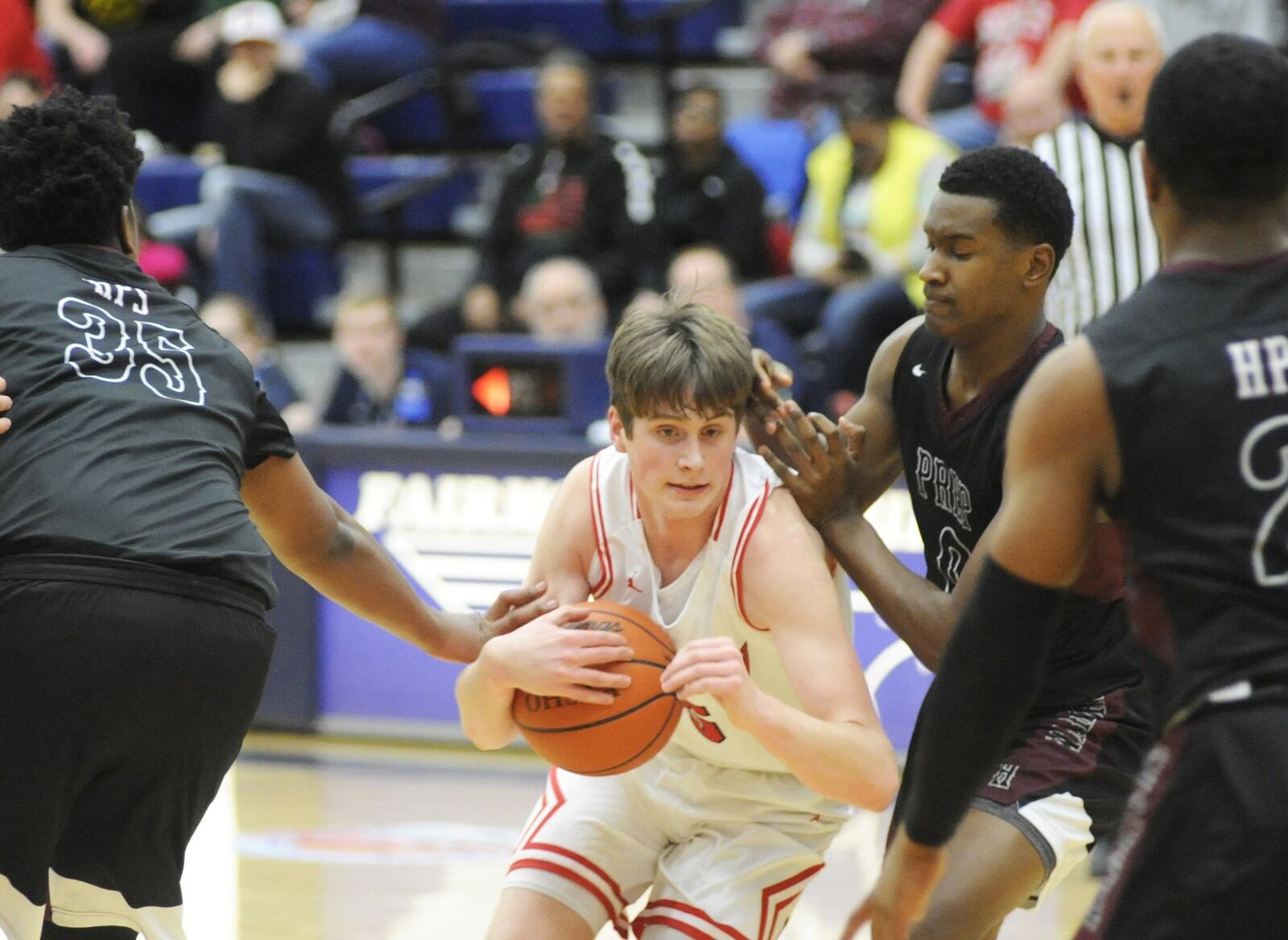 Madison’s Grant Whisman tries to cut through the Canal Winchester Harvest Prep defense during Monday night’s Flyin’ to the Hoop at Fairmont’s Trent Arena. Harvest Prep won 79-56. MARC PENDLETON/STAFF