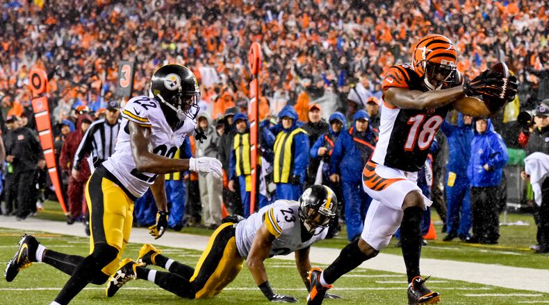 Cincinnati Bengals receiver AJ Green makes a catch and runs it in for a touchdown during their18-16 loss to the Pittsburgh Steelers in the AFC wild card playoff game Saturday, Jan. 9 at Paul Brown Stadium in Cincinnati. NICK GRAHAM/STAFF