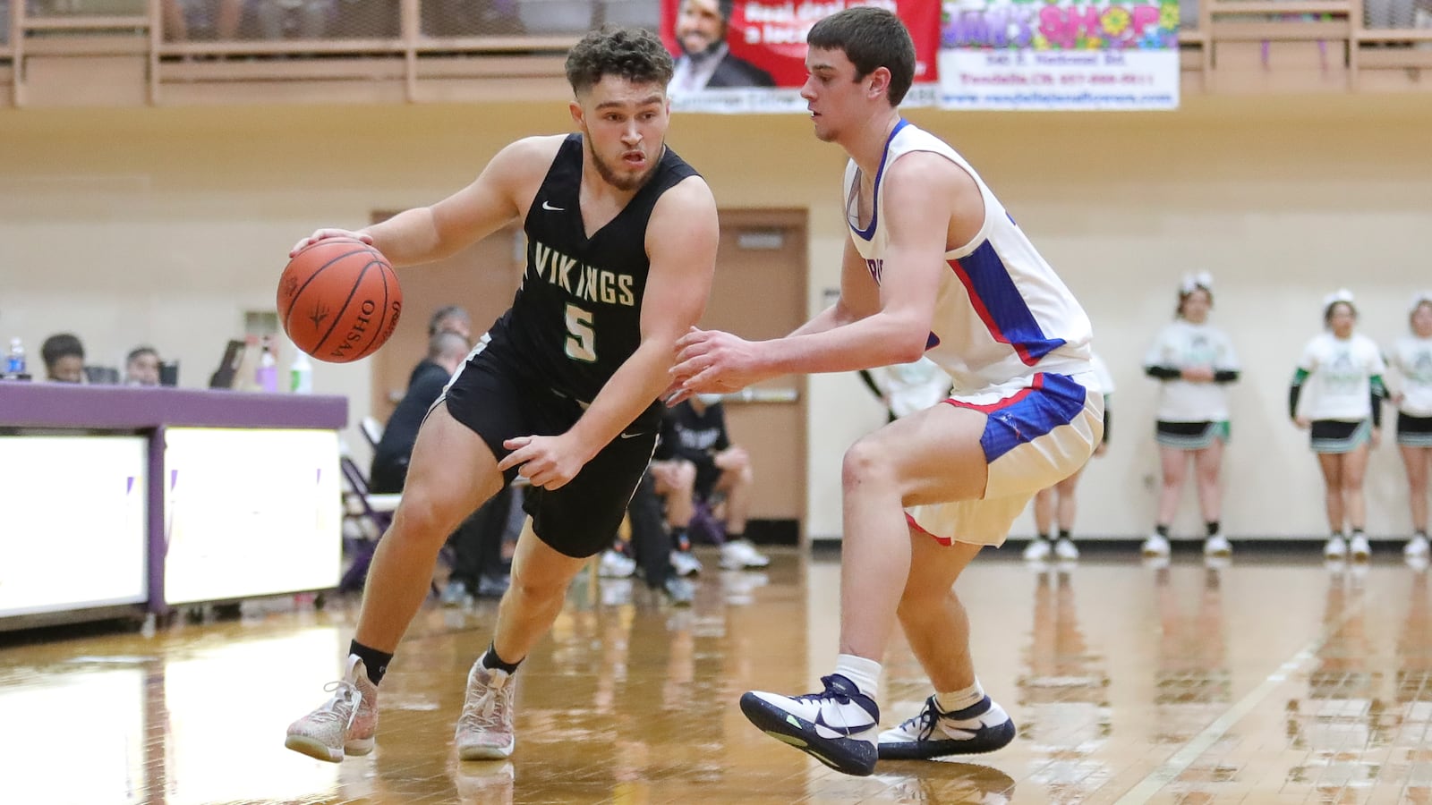 New Miami's Trey Robinette drives past Tri-Village's Justin Finkbine during their D-IV district final game on Saturday afternoon at the Vandalia Butler Student Activity Center. The Patriots won 61-39. Michael Cooper/CONTRIBUTED