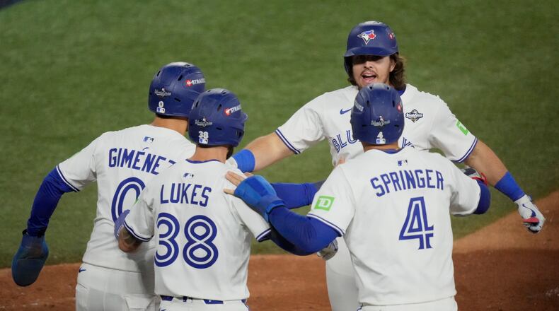 Toronto Blue Jays' Addison Barger celebrates his grand slam home run against the Los Angeles Dodgers during the sixth inning in Game 1 of baseball's World Series, Friday, Oct. 24, 2025, in Toronto. (AP Photo/Brynn Anderson)