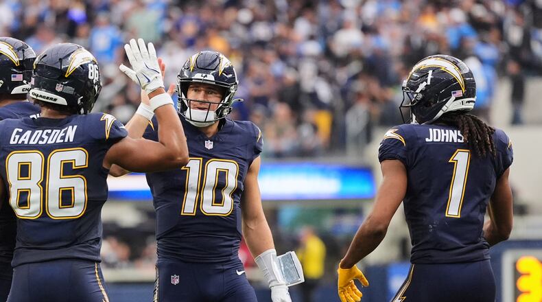 Los Angeles Chargers quarterback Justin Herbert (10) celebrates with tight end Oronde Gadsden II (86) after throwing a touchdown during the second half of an NFL football game against the Las Vegas Raiders, Sunday, Nov. 30, 2025, in Inglewood, Calif. (AP Photo/Jae C. Hong)