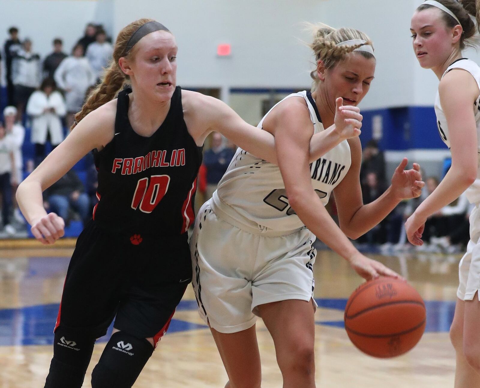 Franklin’s Jordan Rogers (left) and Valley View’s Chloe Smith battle for the ball during Tuesday night’s Division II regional semifinal at Springfield. Franklin won 47-39 in overtime. BILL LACKEY/STAFF