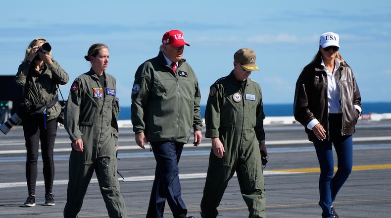 President Donald Trump and first lady Melania Trump walk on the flight deck as part of the Navy's 250th anniversary celebration, aboard the USS George H.W. Bush aircraft carrier in the Atlantic Ocean off the coast of Norfolk, Va., Sunday, Oct. 5, 2025. (AP Photo/Alex Brandon)