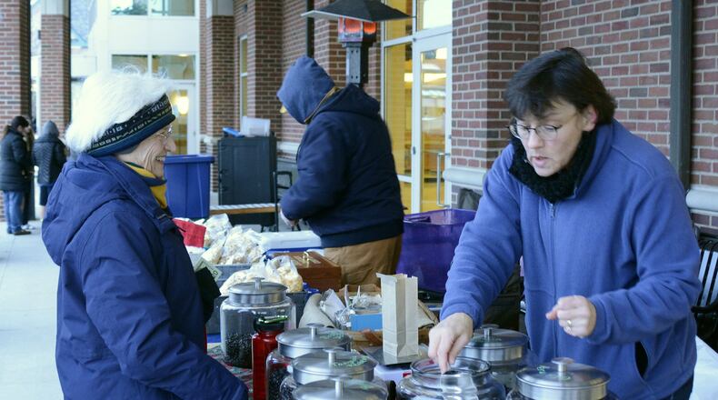 Debra Liston, owner of Mwimbula Fresh Coffee • Fresh Bread serves a customer Wedneday afternoon at a previous year’s Fairfield’s Winter Farmers Market, which runs the second Wednesday of each November through April. Liston’s business donates a portion of proceeds to helping families seeking to adopt special needs children.