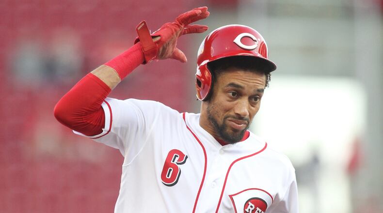 The Reds Billy Hamilton tries to hold onto his helmet as he runs to third base against the Cardinals on Thursday, April 12, 2018, at Great American Ball Park in Cincinnati. David Jablonski/Staff