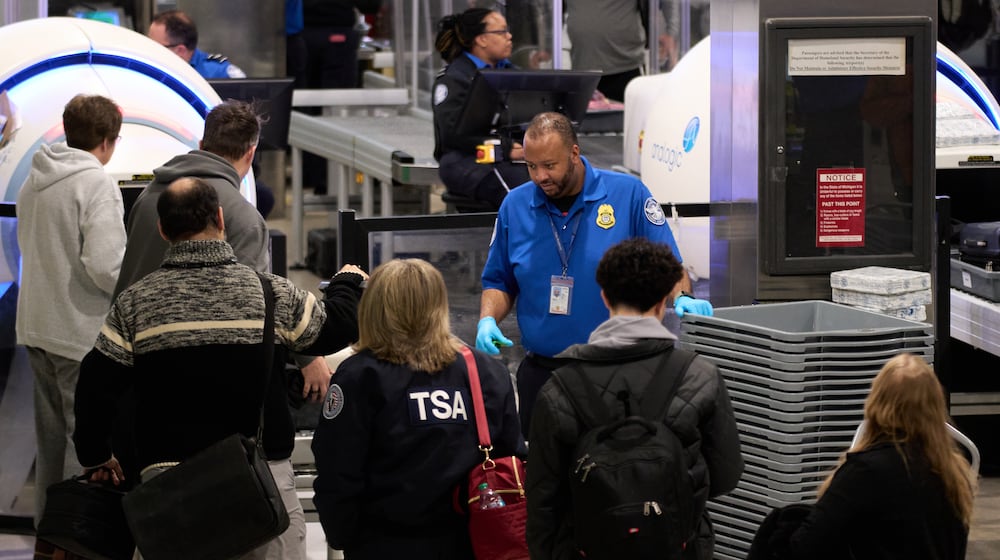 FILE - Travelers wait at a TSA security checkpoint at Detroit Metropolitan Wayne County Airport, Nov. 30, 2025, in Romulus, Mich. (AP Photo/Ryan Sun, File)