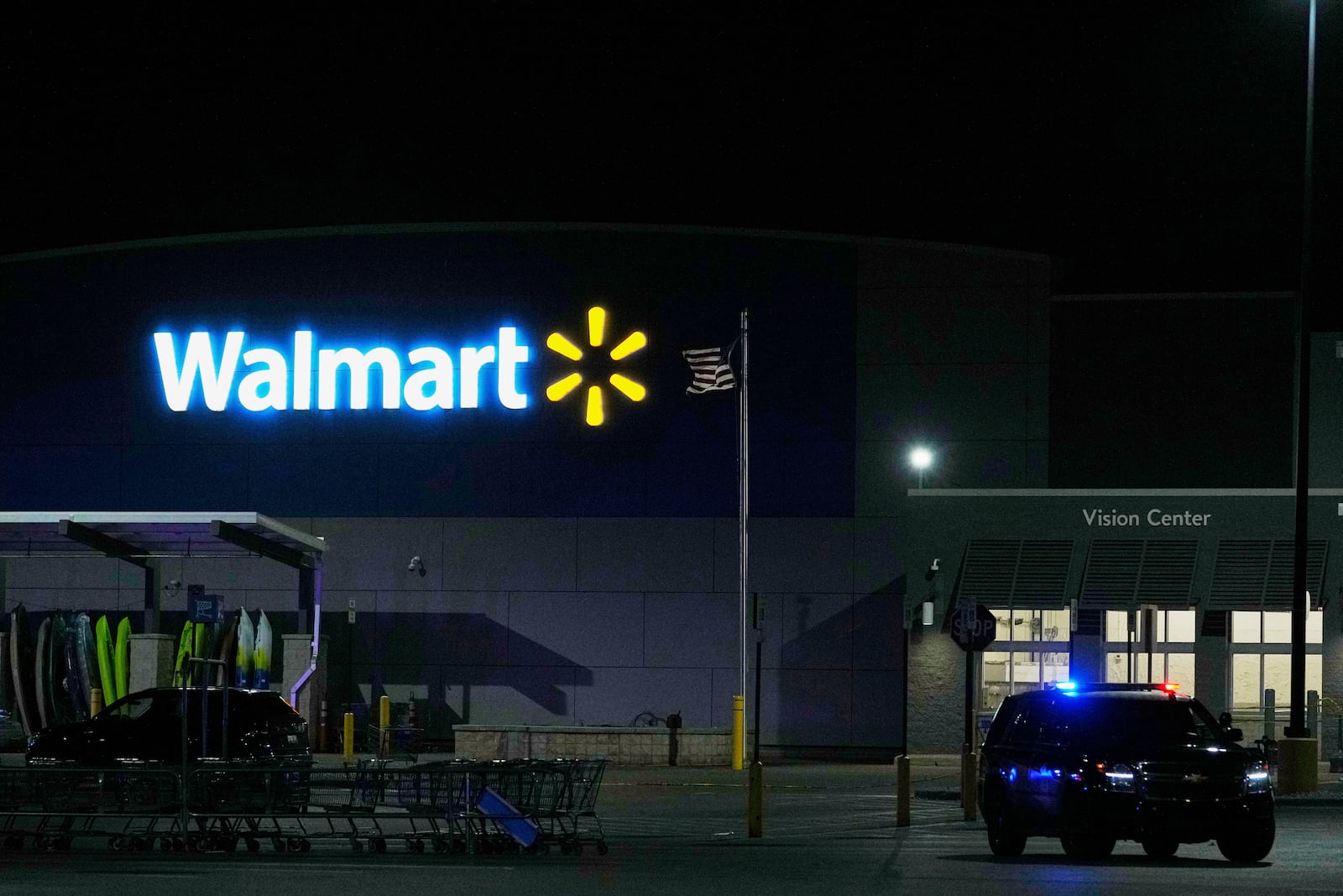 Law enforcement officers are seen stationed outside a Walmart where 11 people were stabbed in a violent attack Saturday, July 26, 2025, in Traverse City, Mich (AP Photo/Ryan Sun)