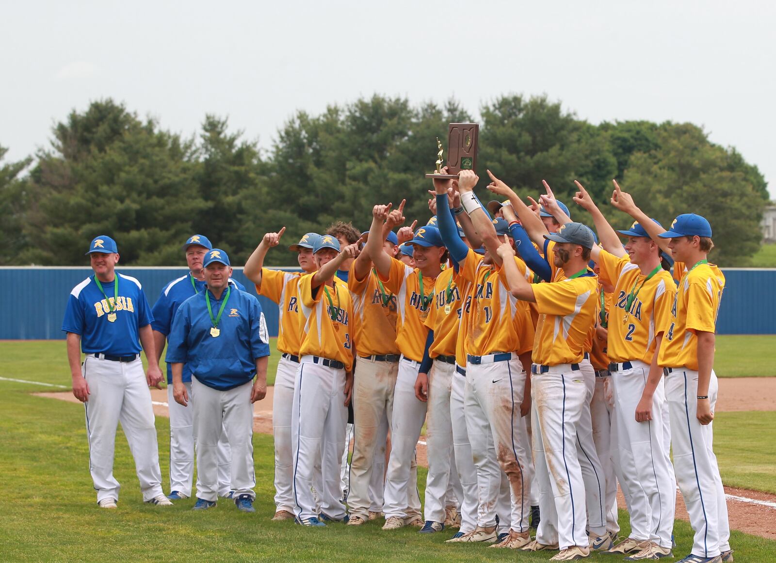 The Russia High School baseball team lifts the regional championship trophy after beating Cedarville in a Division VII regional final game on Thursday, June 5 at Cedarville University. MARCUS HARTMAN / STAFF