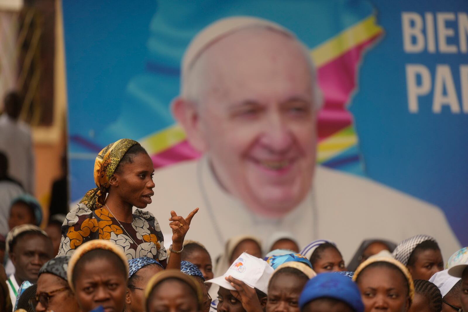 FILE - People wait for the arrival of Pope Francis for a meeting with priests, deacons, consecrated people and seminarians, outside the "Notre Dame du Congo" Cathedral in Kinshasa, Democratic Republic of Congo, Feb. 2, 2023. (AP Photo/Gregorio Borgia, File)