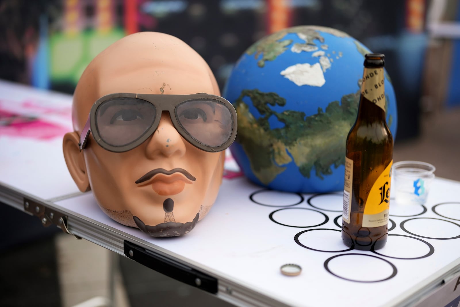 A Pitbull mask on a beer pong table on Monday, June 9, 2025, in London. (Photo by Scott A Garfitt/Invision/AP)