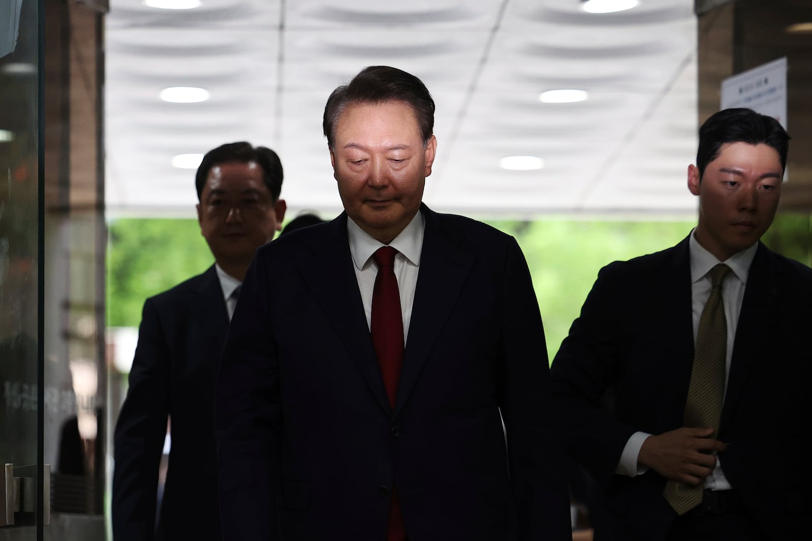 Former South Korean President Yoon Suk Yeol, centerm arrives at a court to attend a hearing to review his arrest warrant requested by special prosecutors in Seoul, South Korea Wednesday, July 9, 2025. (Kim Hong-Ji/Pool Photo via AP)