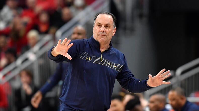 Notre Dame head coach Mike Brey sends instructions to his team during the second half of an NCAA college basketball game against Louisville in Louisville, Ky., Saturday, Jan. 22, 2022. Notre Dame won 82-70. (AP Photo/Timothy D. Easley)