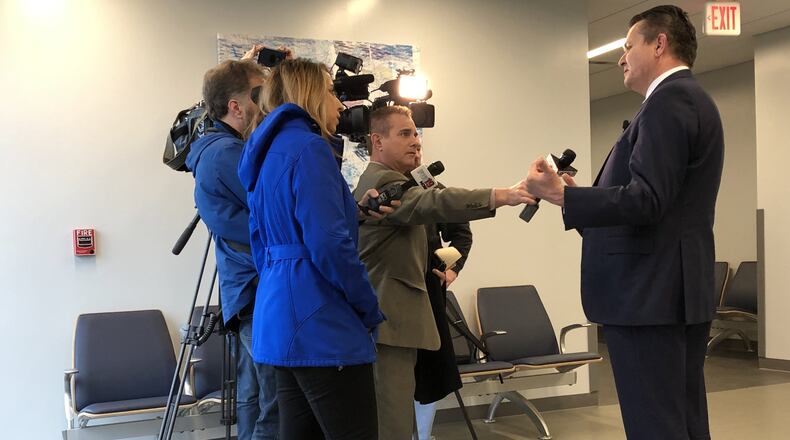Judge Joe Kirby has scheduled hearings in July for four area teens facing murder charges in Warren County. Patrick Mulligan, a defense attorney in the case, answers questions during the last hearing in February. LAWRENCE BUDD/STAFF