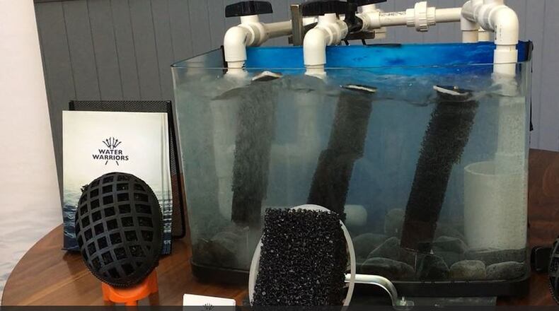 This tank is a tiny model of a product that the Water Warriors manufacture, with the black structures that house bacteria to eliminate contaminants like nitrogen and phosphorous. MIKE RUTLEDGE/STAFF