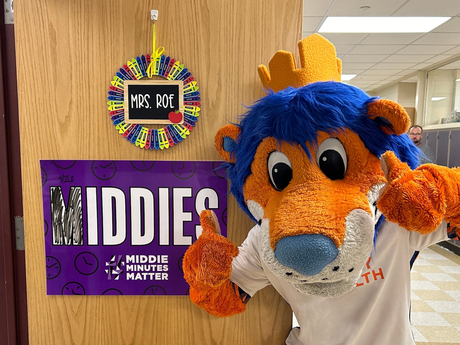 Gary the Lion, FC Cincinnati's mascot, poses in front of a teachers' door in Middletown Schools. Courtesy of Middletown Schools. Middletown Schools officials say the district partnered with the Stay in the Game Foundation, which connects professional sports to schools and promotes attendance.