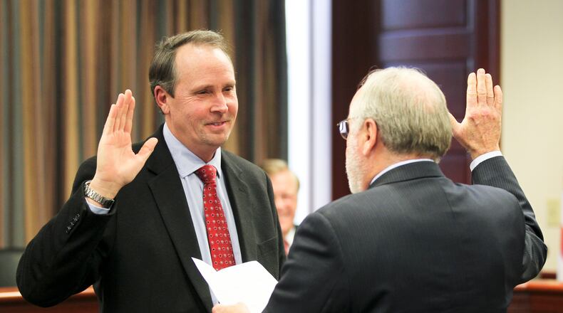 Robert Brown has pulled petitions to seek re-election to Hamilton City Council. He is pictured here during his swearing-in ceremony in 2014. GREG LYNCH / STAFF 2014