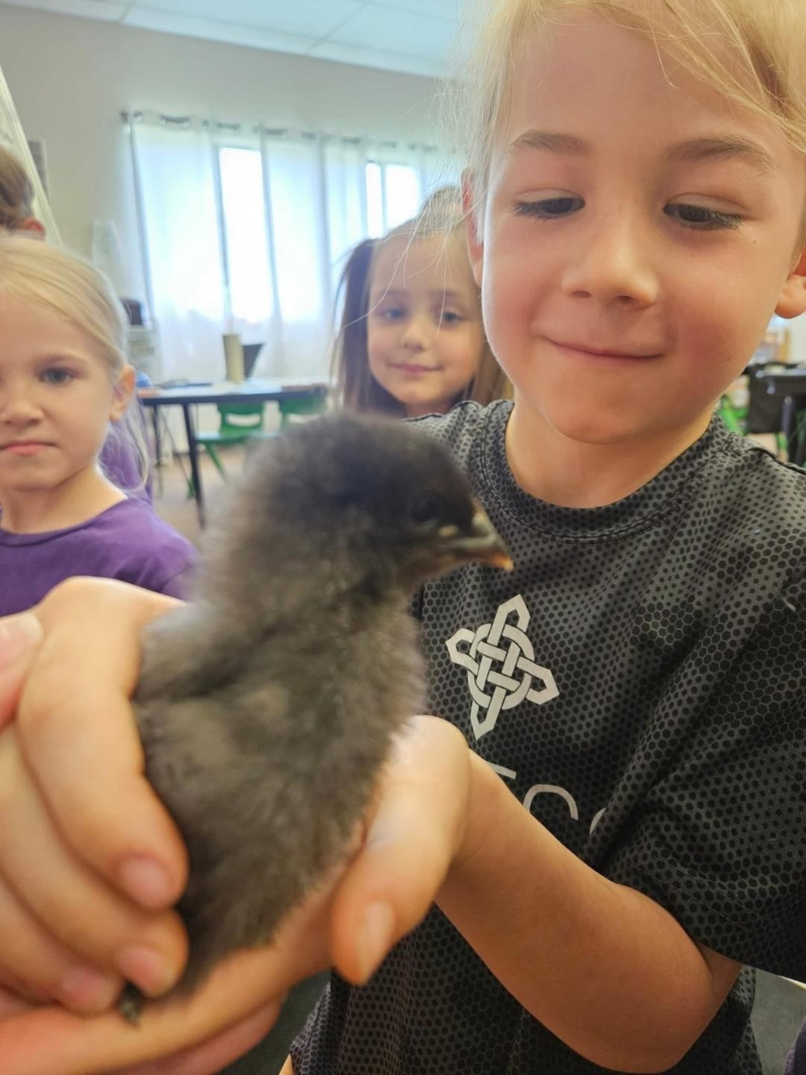 Kirk Wilson holding a duck in his classroom. CONTRIBUTED