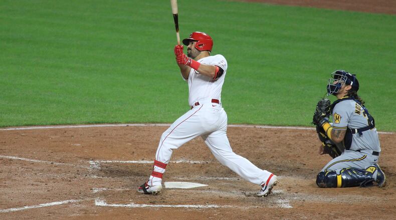 Eugenio Suarez, of the Reds, rounds the bases after hitting a three-run home run against the Brewers on Wednesday, Sept. 23, 2020, at Great American Ball Park in Cincinnati. David Jablonski/Staff