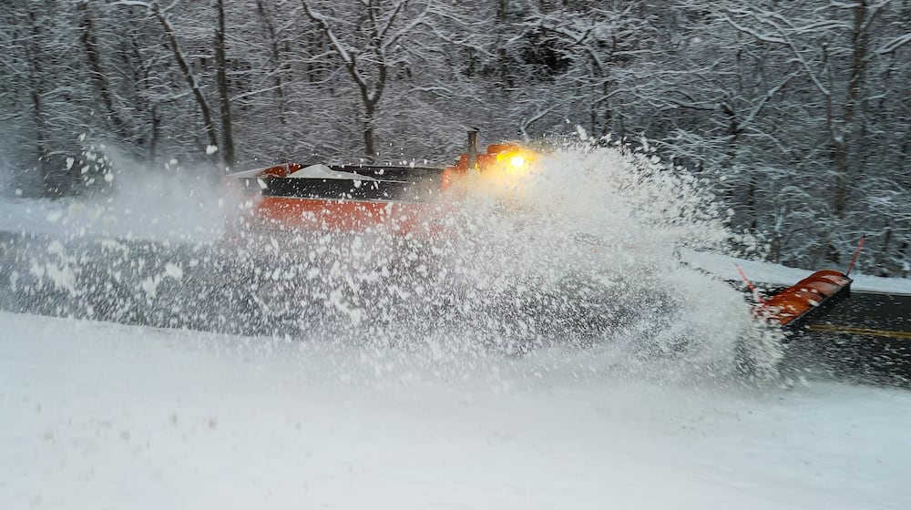 A plow clears Elk Creek Road after several inches of snow fell Tuesday, Dec. 2, 2025 in Madison Township in Butler County. NICK GRAHAM/STAFF