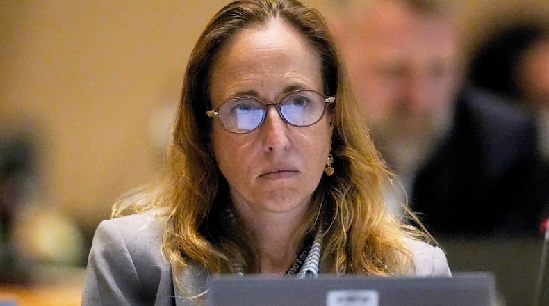 FILE - Dr. Tracy Beth Hoeg, with the FDA, listens during a meeting of the Advisory Committee in Immunization Practices at the CDC, June 25, 2025, in Atlanta. (AP Photo/Mike Stewart, File)