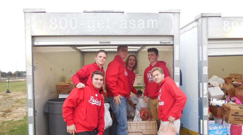 Lakota West students help load donations during last year’s “Reach In for Reach Out Lakota district-wide food drive. This year’s competition starts Monday.