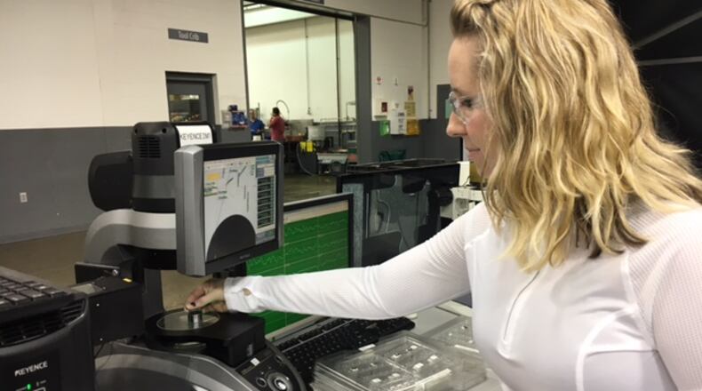 Veteran Norwood Medical employee Becca Hummer inspects parts in a March 2017 photograph. THOMAS GNAU/STAFF
